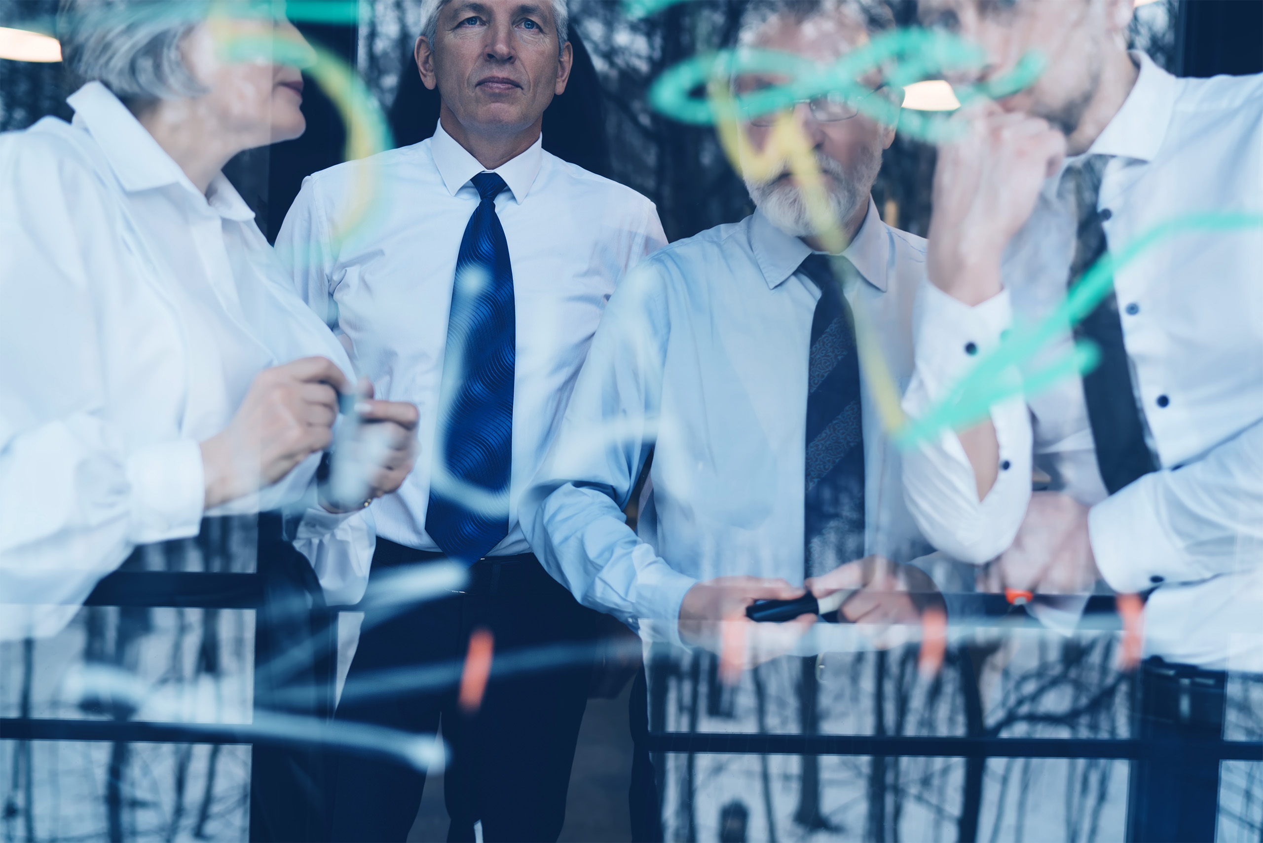 Focused coworkers communicating while making plan